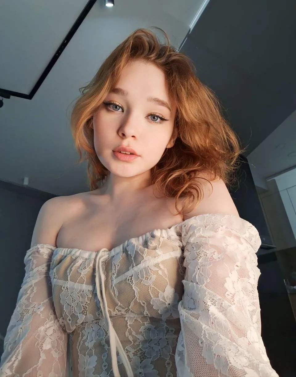 Original softly lit portrait of Lina wearing an off-the-shoulder white lace dress