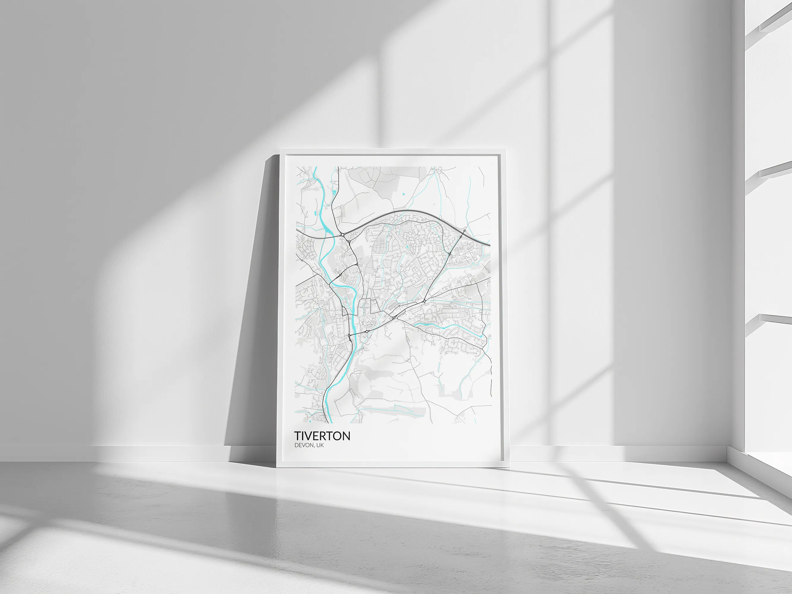 Light-coloured Tiverton street map displayed in a white frame in a sunlit interior